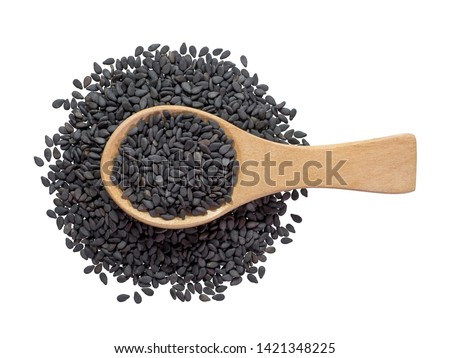Black sesame seeds in wooden spoon pile and spread isolated on white background.Scientific name is Sesamum orientale L.Herb.cereal, Top view. Royalty-Free Stock Photo #1421348225