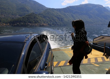 Young woman with dog on Como lake, Italy 