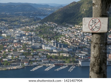 Sign prohibiting flying witches on a broomstick with the European city on background.