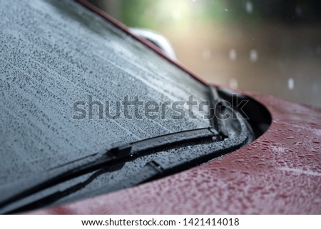 Cars parked in the rain in the rainy season and have a wiper system to clear the windshield from the windshield., Close-up car rain wipers, rainy weather and vehicles concept
