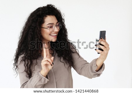 lifestyle, technology and people concept - young african woman taking selfie with smartphone over white background
