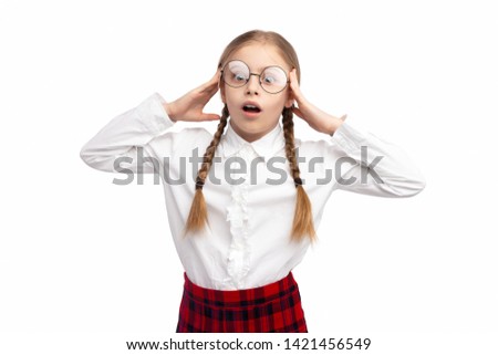 Nerdy girl in school uniform and glasses rubbing temples while having headache during studies against white background