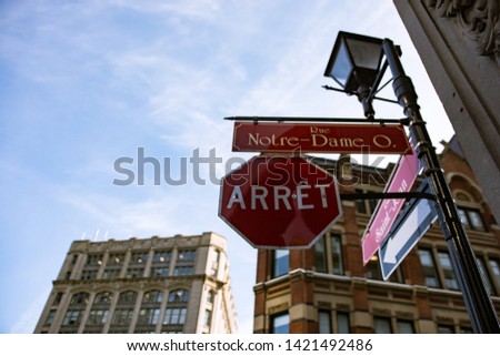 Rue Notre Dame Ouest - old Montréal street signs. Canada red stop sign - arrêt