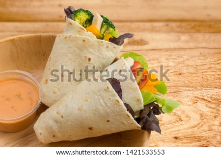 Salad Kebab, Pita bread, Tortilla wrap with mixed vegetable, in wooden bowl, healthy meal for grab & go food, with salad sauce thousand island dressing, spoon ready to eat on isolated white background Royalty-Free Stock Photo #1421533553