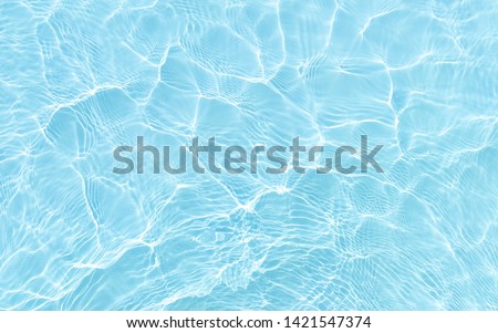 bright ripple surface of light blue swimming pool with sun reflect view from top see through floor ,abstract clean water glare detail for texture background or wallpaper Royalty-Free Stock Photo #1421547374