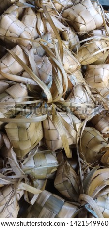 Ketupat, special dish served at Eid Mubarak / Ied Fitr celebration in Indonesia. Ketupat is is a type of dumpling made from rice packed inside a diamond-shaped container of woven palm leaf pouch.