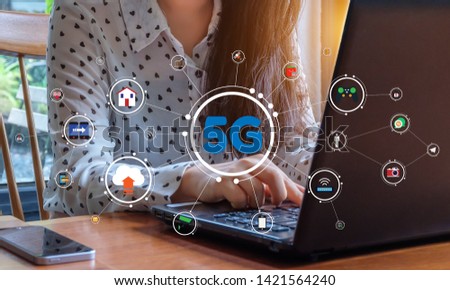 Business woman is working with laptop over 5G internet. 5G network illustration graphic.