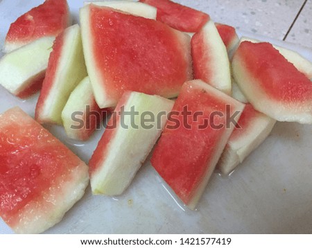 Fresh watermelon rind on a white chopping board