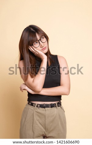 Beautiful young Asian woman get bored  on beige background