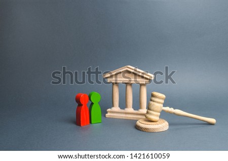 Two figures of people opponents stand near the courthouse and the judge's gavel. Conflict resolution in court, claimant and respondent. Court case, settling disputes. The judicial system. Royalty-Free Stock Photo #1421610059