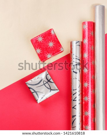Golden gift boxes and red wrapping paper on bright background.Top view flat lay group objects