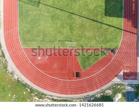 aerial view on Half of soccer field, football field with Numbers on red running track. race track in a opened stadium. Royalty-Free Stock Photo #1421626685