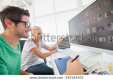 Photo editors working on photograph with graphics tablet Royalty-Free Stock Photo #142164103