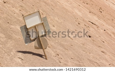 abandoned broken road sign in sandy desert wasteland polluted environment,   catastrophic injury wallpaper pattern concept picture with empty copy space for text or inscription 
