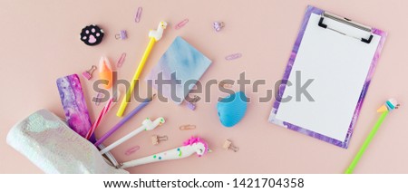 School stationery with unicorn pen, lama pencil on a pink background. Back to school creative table desk with kawaii stationery, flatlay and top view. Panoramic backdrop Royalty-Free Stock Photo #1421704358