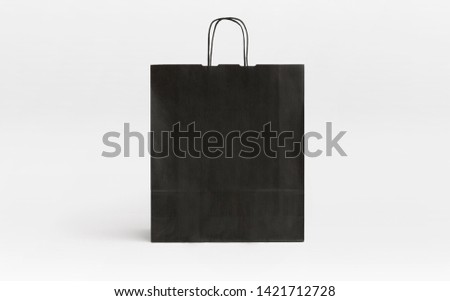 black paper bag with stripes front