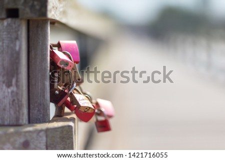 engraved padlocks hanging on a bridge as a symbol for lovers