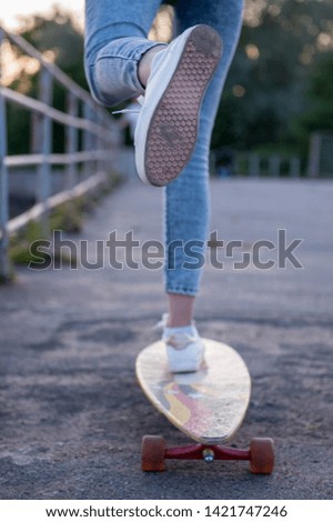 Girl with longboard wearing sneakers shoes in urban style