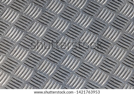 Silver steel metal plate with surface and safety diamond texture, The old metal flooring sheet in white colour, Seamless grey texture pattern background.