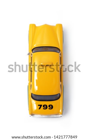 Yellow taxi seen from above on a white background
