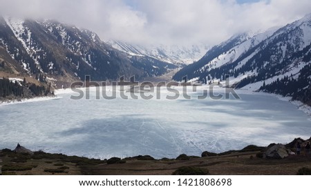 Winter. Mountain lake covered with ice.