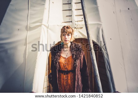 beautiful Young boho styled woman in a Sioux tent 
