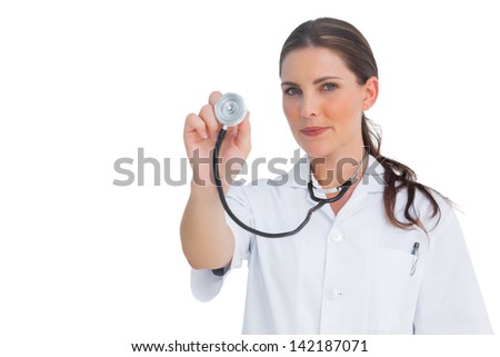 Nurse holding up her stethoscope on white background