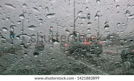 Blurred through car windows with rain drop. Selective focus. 
