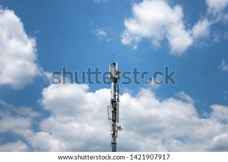 Telephone broadcast column against blue sky
