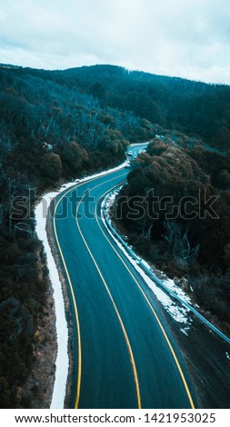 Aerial View of Road and Forest in Snow