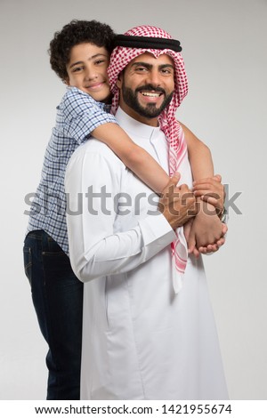 Studio Portrait of Father and Son Royalty-Free Stock Photo #1421955674