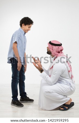 Studio portrait of arab father and son Royalty-Free Stock Photo #1421959295
