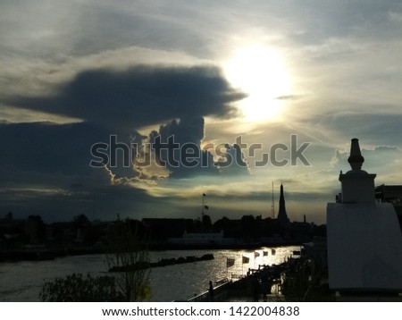 Bangkok skyline silhouette and temple of dawn over the Chao Phraya River