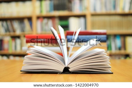 Open book on table in library
