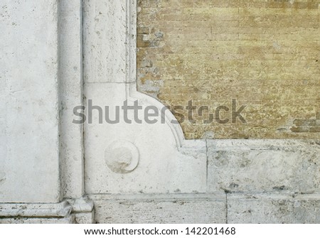 Abstract detail of an ancient brick wall with some marble decoration