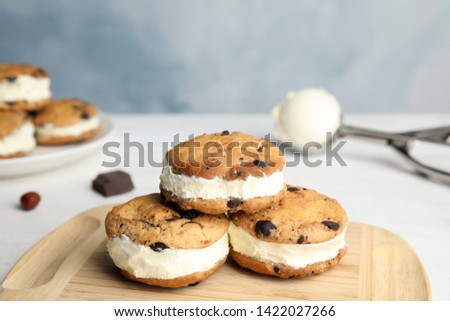 Sweet delicious ice cream cookie sandwiches on table