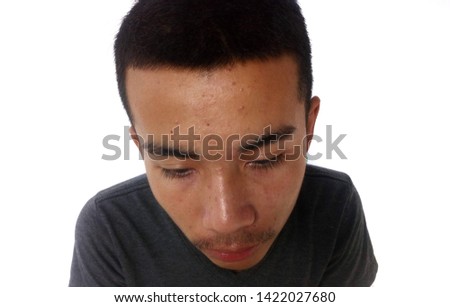 Asian male teenager doing bored expression.