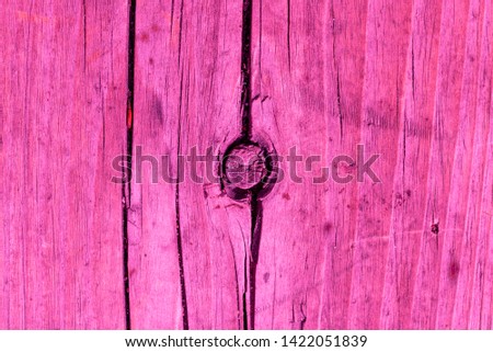 Abstract pink wooden background. Natural wood Board is painted in pink color. Close up.