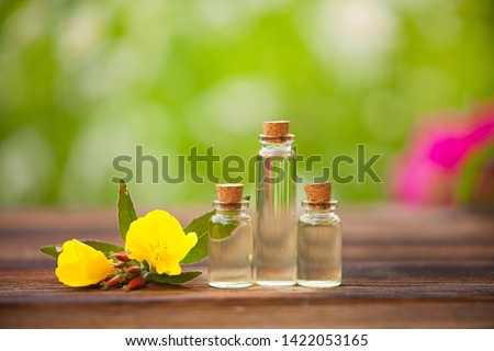 sundrops essential oil in a beautiful bottle on the wooden background Royalty-Free Stock Photo #1422053165