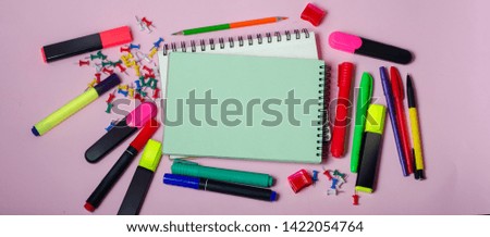 Back to school concept. Notebooks and with pencils, markers on pink background with place for text.