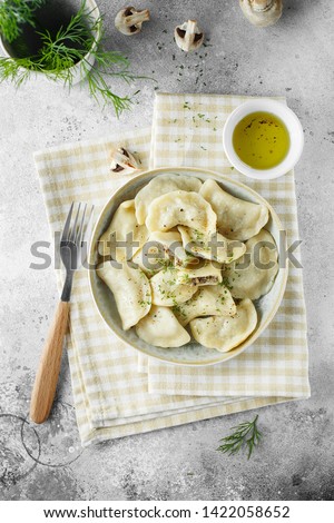 Dumplings, filled with mushrooms Champignon. Russian, Ukrainian or Polish dish: varenyky, vareniki, pierogi, pyrohy. Food photography. flat lay composition