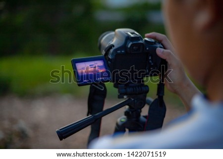 photography man take a photo of landscape of sunset background, camera equipment for shoot picture