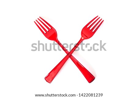 Crossed  disposable plastic red forks isolated on white background. Ecology problem. No plastic concept. Top view.