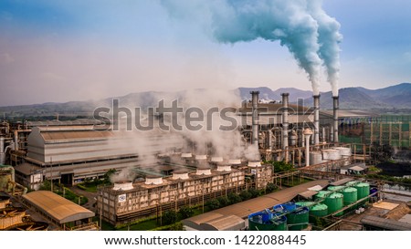 Smokestack pipe factory pollution in the city, Fuel Power Plant Smokestacks Emit Carbon Dioxide Pollution, Ecosystem and healthy environment concepts and background. Royalty-Free Stock Photo #1422088445