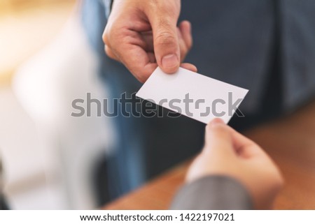 Two businessman holding and exchanging empty business card 