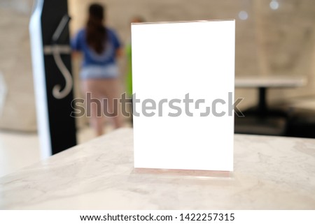 Mock up Menu frame in shopping mall,Stand for booklets with white sheets of paper acrylic tent card on table on. 