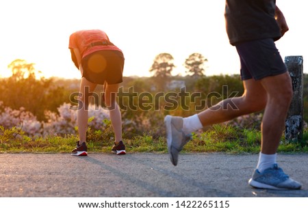 woman tired on running jogging exercise by hand resting on the knees, workout running of woman unfit and tired often Royalty-Free Stock Photo #1422265115
