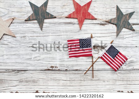 Fourth of July Background. Wooden stars with American flags over a white rustic background to celebrate America's Independence Day. 