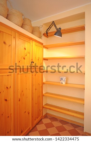 interior of apartment with wooden cabinet, shelves and  bookcase typical of mountain lodges and houses