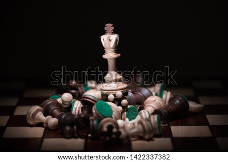white chess on the top of number of chess pieces , business strategy concept